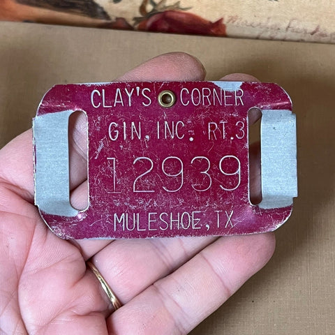 T7: red metal cotton gin bale tag from Muleshoe, Texas