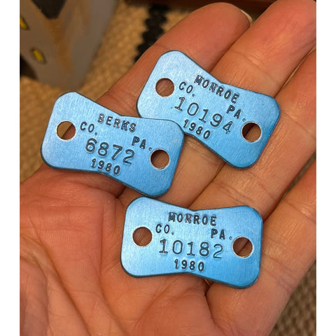 T26. 3 aluminum dog tags from 1980